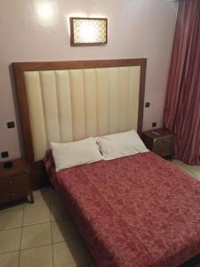 卡萨布兰卡博斯坦酒店的一间卧室配有一张带红色毯子的大床