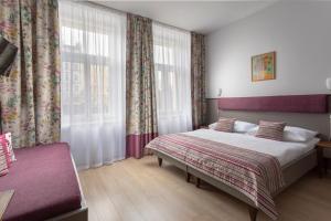 布拉格布拉格市中心广场酒店的一间卧室设有一张大床和一个窗户。