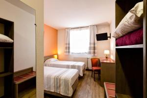 里昂卢米埃尔酒店的酒店客房设有两张床和窗户。