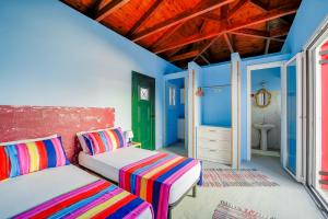 DhavgátaArt Studio Kefalonia的蓝色墙壁客房的两张床