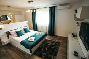 克卢日-纳波卡Briana Luxury Apartment的一间卧室配有一张带蓝色枕头和镜子的床