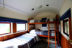 怀托摩洞穴伍德林公园汽车旅馆的一间带两张双层床的火车卧室