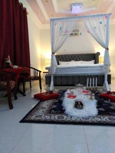 IbrāTafadal的一间卧室配有一张床和一张带蜡烛的桌子