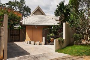 奥南海滩Baan Manuchang Villa, SHA Certified的一座带门和栅栏的房子