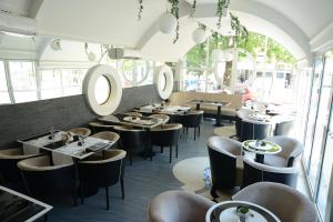 克拉古耶瓦茨泽那瓦酒店的餐厅设有桌椅和窗户。