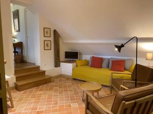 Dragey勒多米尼贝尔维尔酒店的客厅设有黄色沙发和电视
