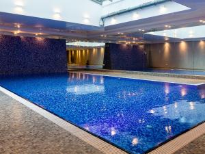格但斯克Euro Apartments Szafarnia Delux的大楼内一个蓝色的大型游泳池