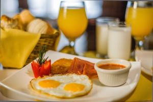 坎昆Airport Bed and Breakfast的桌上一盘早餐食品,包括鸡蛋和草莓