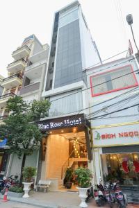 海防HOTEL Blue Rose的城市街道上一座有商店的建筑