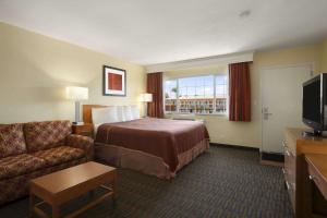 圣地亚哥圣地亚哥海洋世界豪生酒店的酒店客房配有床、沙发和电视。