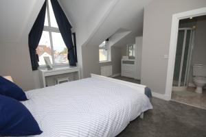 斯图尔特港Strand House 2的卧室配有白色的床和窗户。