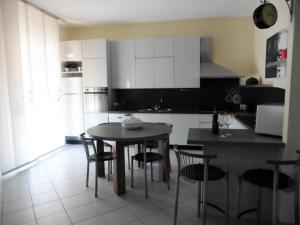 波焦阿卡伊阿诺Appartamento il Veggio的厨房配有桌椅
