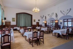 吕本Hotel & Restaurant Lindengarten的一间带桌椅和吊灯的用餐室