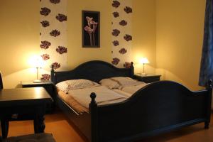 汉堡Sohre的一间卧室配有一张床、两张桌子和两盏灯。