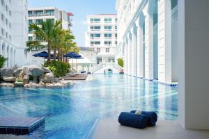 芭东海滩Mövenpick Myth Hotel Patong Phuket的一座大楼中央的游泳池