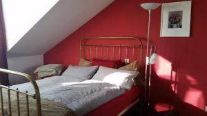 杜塞尔多夫大学安静公寓的红色的卧室,配有一张红色墙壁的床