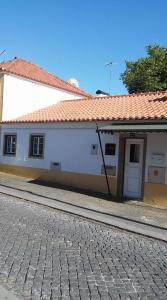 辛特拉Casa Da Tulha的一条白色的建筑,在街道旁有红色的屋顶