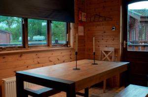罗厄德南Caol Gleann Lodge的一张木桌,上面有两根蜡烛