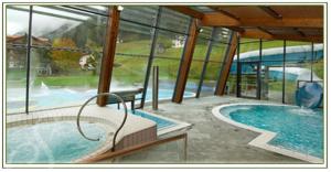 奥蒂塞伊苏雷格伊思酒店的一座带大窗户的建筑中的游泳池