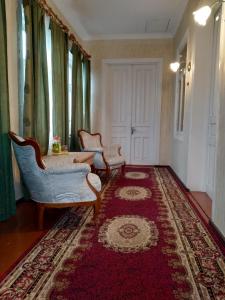 库塔伊西Guesthouse Gegi的客厅配有两把椅子和地毯。