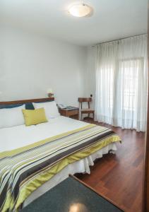 佩雷亚阿吉利酒店的一间卧室设有一张大床和一个窗户。