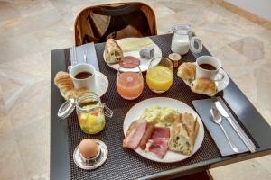 巴黎塞弗尔圣日尔曼酒店的一张桌子,上面有一盘早餐食品和饮料