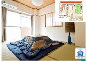 大阪Daihan Building / Vacation STAY 3300的卧室配有一张床,上面放着一只猫