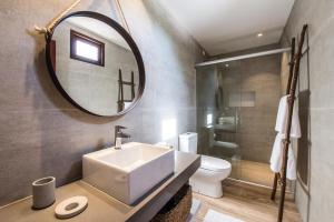 费尔南多 - 迪诺罗尼亚Casa Amarela的一间带水槽、镜子和卫生间的浴室