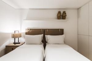 费尔南多 - 迪诺罗尼亚Casa Amarela的卧室内两张并排的床