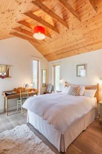 肯梅尔Kenmare Eco Lodge的一间卧室设有一张带木制天花板的大床