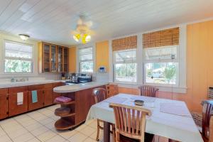 PapaikouHamakua Hale Ohana Country Retreat的厨房配有桌椅和窗户。