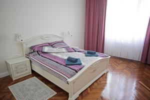 贝尔格莱德City Center Belgrade Queen Apartment Skadarlija的一张白色的床,上面有两条蓝色的毛巾