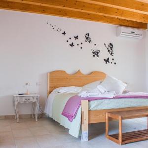 佩斯基耶拉德加达Orchidea Del Garda的卧室配有一张床上的蝴蝶壁床。