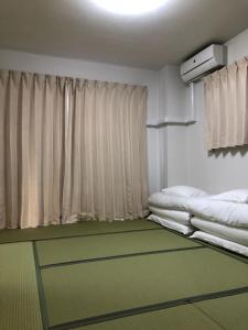 千叶First Hongo Building 202 / Vacation STAY 3355的客房设有两张床和窗户。
