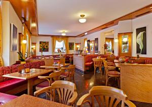 马克特奥伯多夫Hotel Greinwald的一间带桌椅的餐厅和一间酒吧