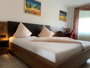 拉姆斯泰因-米森巴赫欧洲酒店的一张带白色床单和枕头的床
