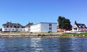 马斯塔尔Hotel Udsigten Marstal的水体岸边的一群房子