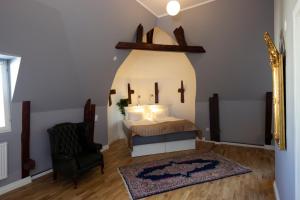 厄勒布鲁亚尔马酒店的一间卧室配有一张床、一把椅子和镜子