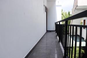 米瑞莎Sakura Calm Rest的阳台设有黑色栏杆和白色墙壁。