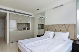内坦亚Netanya SeaView ApartHotel的一间卧室配有一张带白色床单的大床