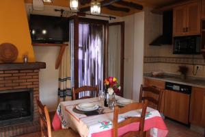 卡皮雷拉Apartamentos Rurales Rosendo: "Suite Veleta"的一间带桌子的用餐室和一间厨房
