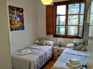 乌贝达Sol Hospital Santiago的客房设有两张床和窗户。