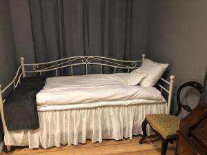 斯克伦达Skrunda Apartments Elandrum的一张带金属框架和白色床单及枕头的床