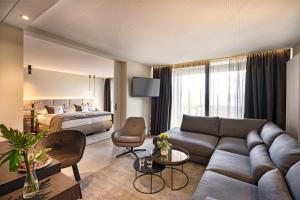 巴特法兴格Hotel Riedenburg的客厅配有沙发和1张床