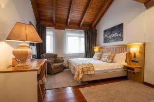 巴奎伊拉-贝莱特Eira Ski Lodge的一间卧室配有一张床和一张带台灯的书桌
