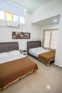 龙运Umbut Bayu的一间卧室设有两张床和窗户。