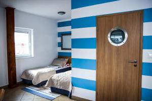 鲁斯诺沃萨格拉米旅馆的一间拥有蓝色和白色条纹墙和门的房间