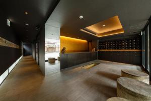 京都Hotel Ninja Black的品酒室,配有凳子和葡萄酒瓶