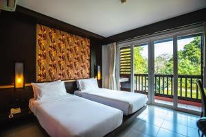 Ratana Hotel Chalong客房内的一张或多张床位
