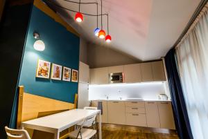 都灵Juvarrahouse Luxury Apartments的厨房配有白色桌子和蓝色的墙壁